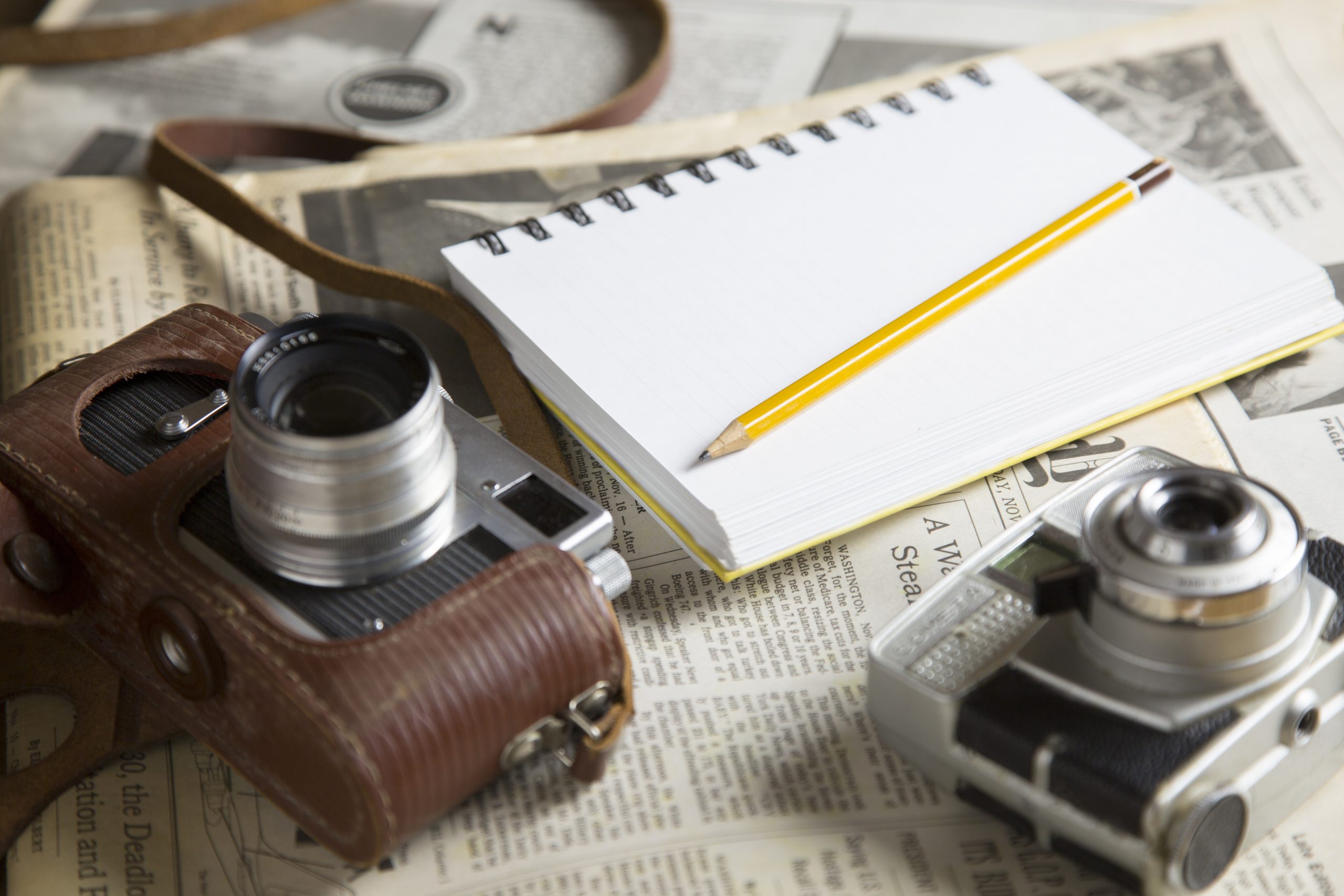 Journalist tools sitting on top of newspaper